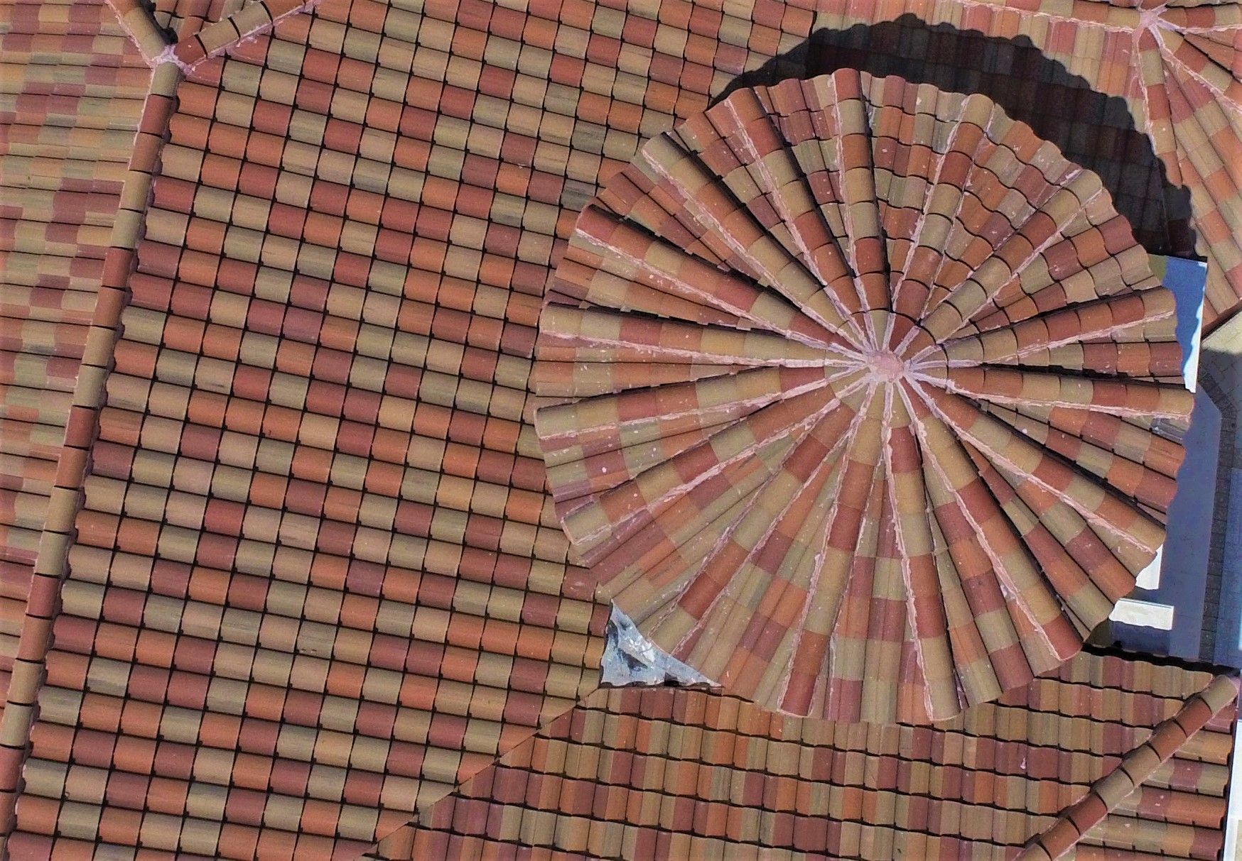 The roof of a building has a circular design on it