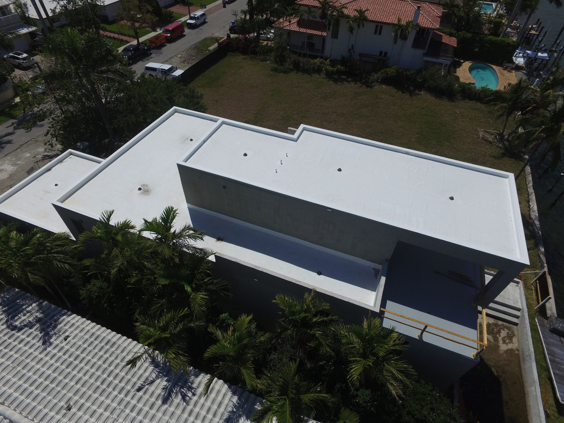 An aerial view of a house with a white roof
