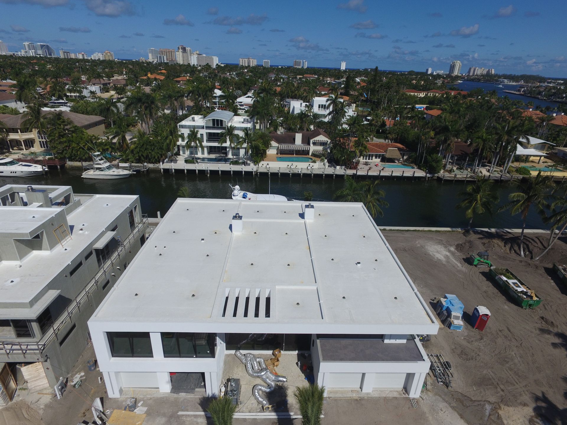 An aerial view of a house with a white roof