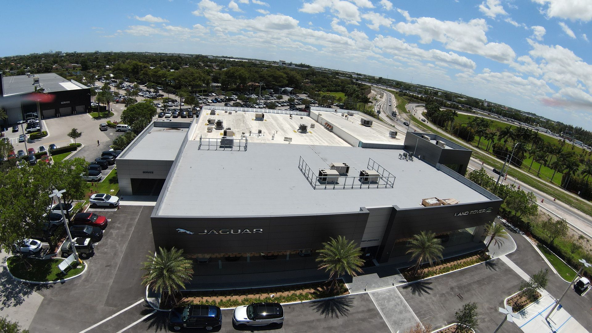 An aerial view of a large building with a parking lot in front of it