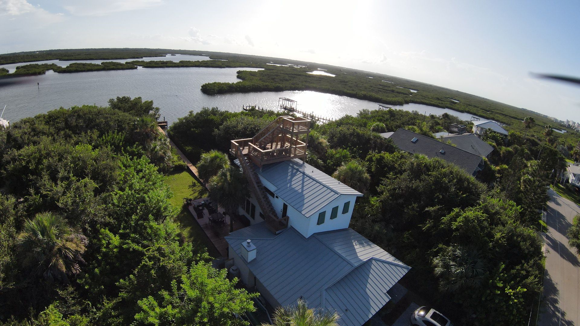 An aerial view of a house near a body of water