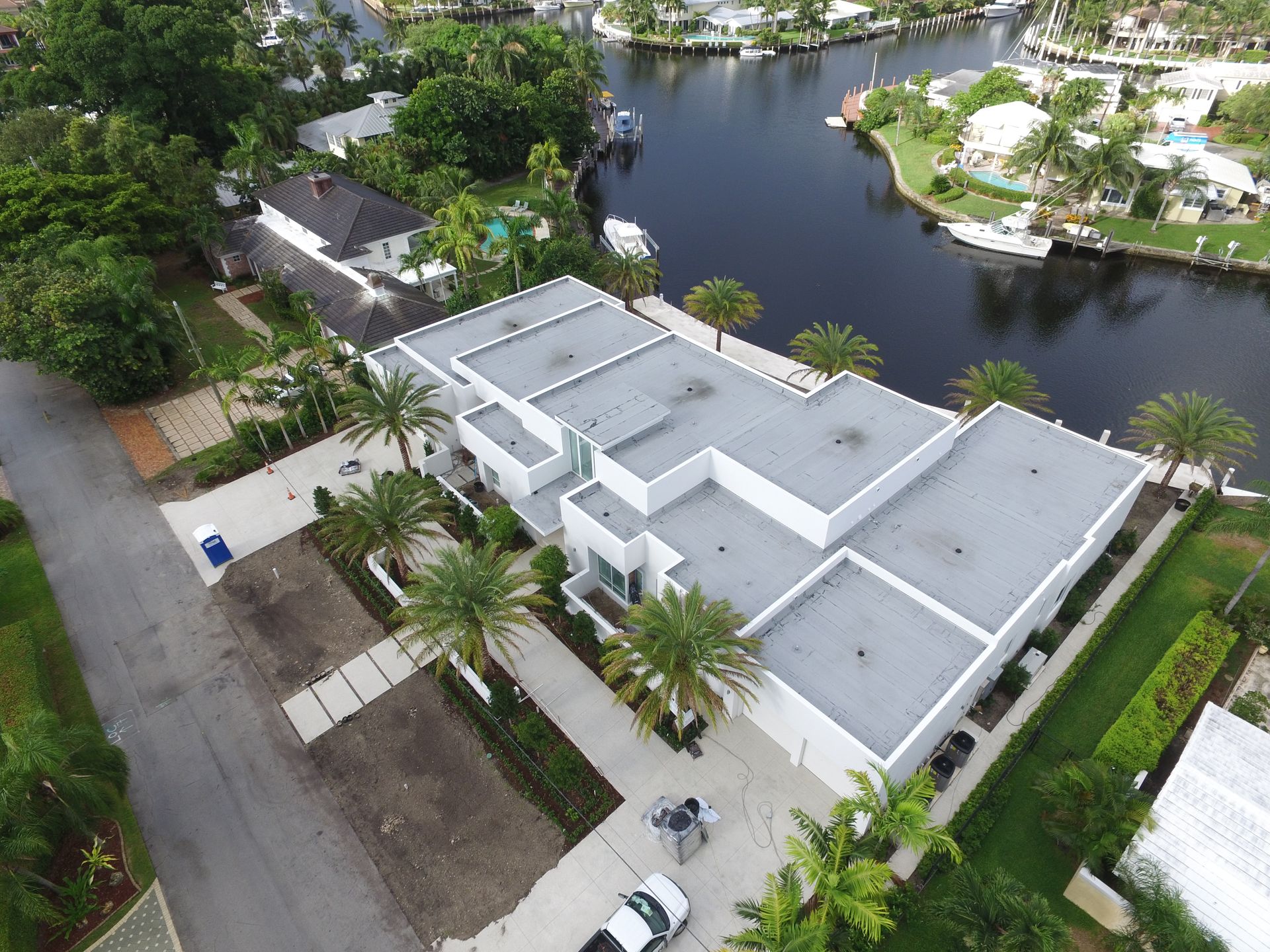 An aerial view of a house next to a body of water