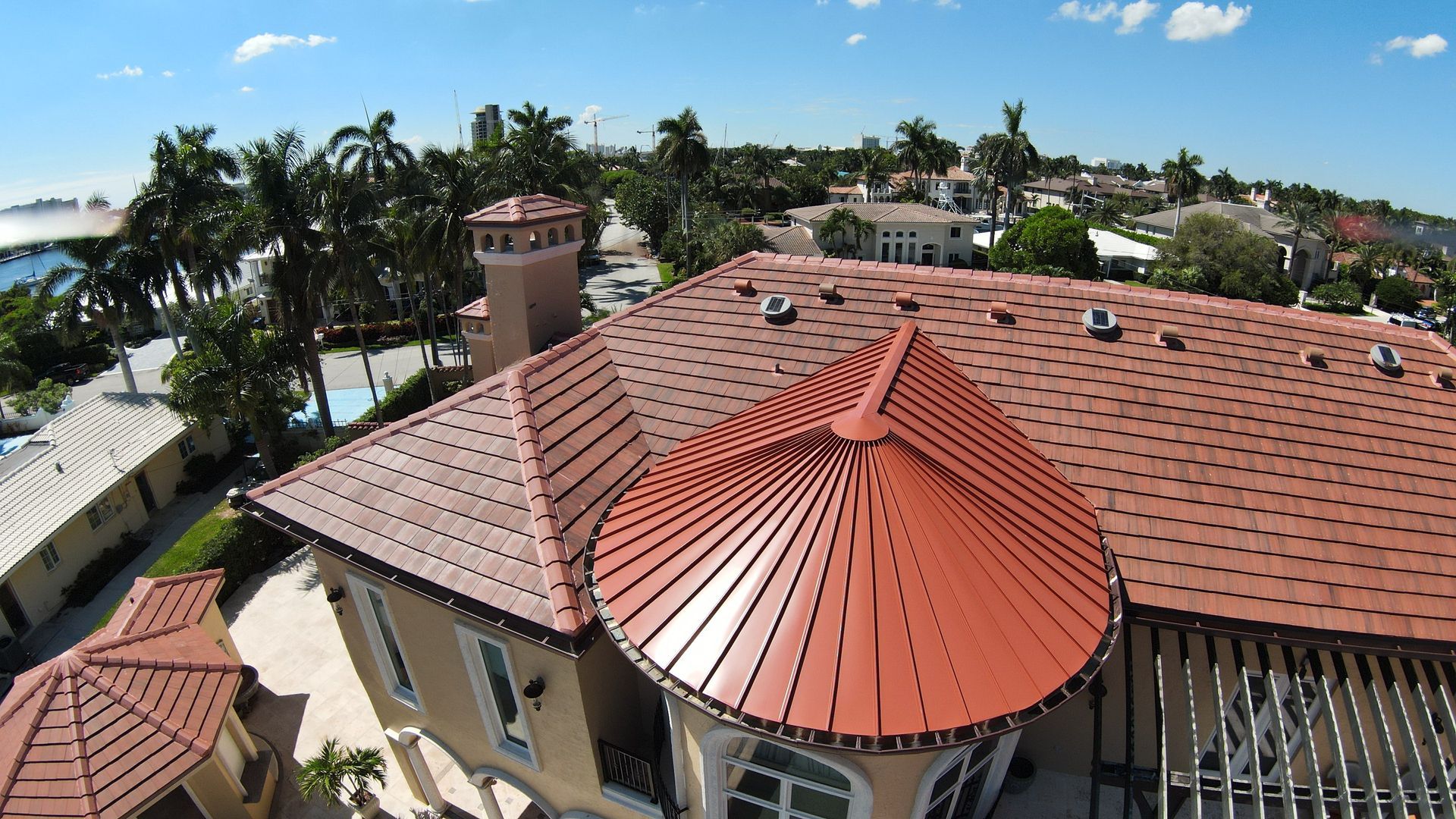 An aerial view of a house with a red tile roof
