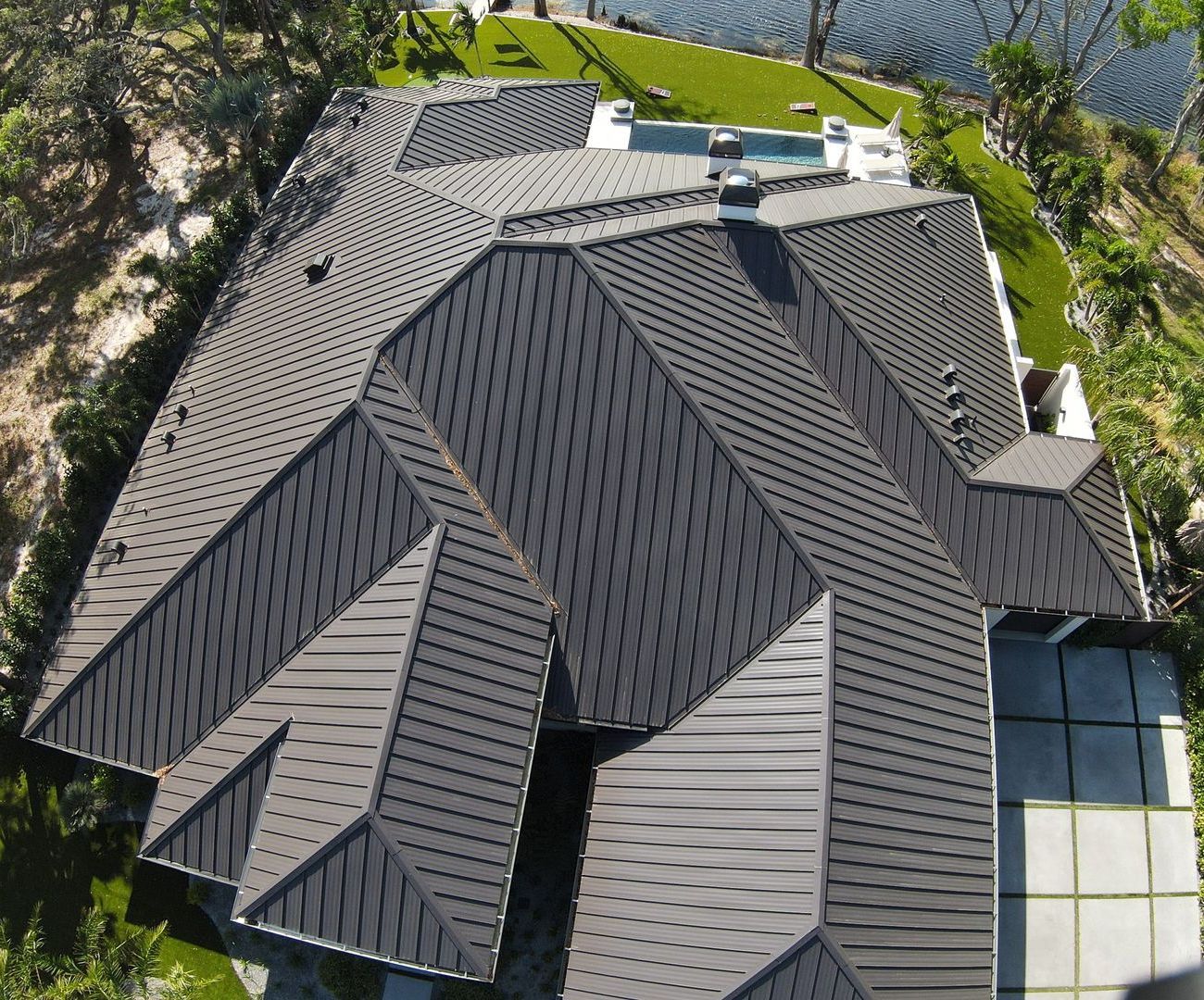 An aerial view of a house with a large roof