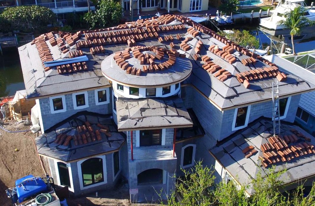 An aerial view of a large house under construction
