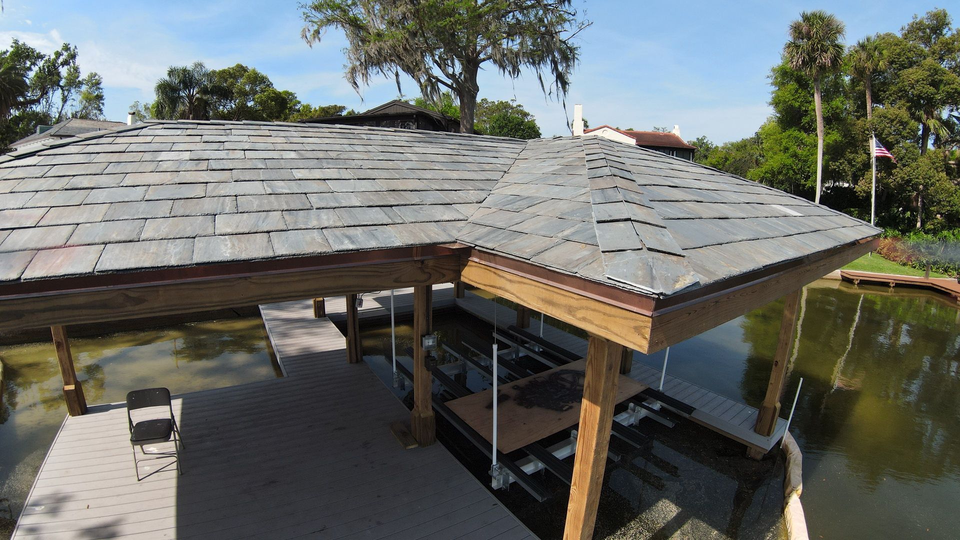 A roof over a dock overlooking a body of water