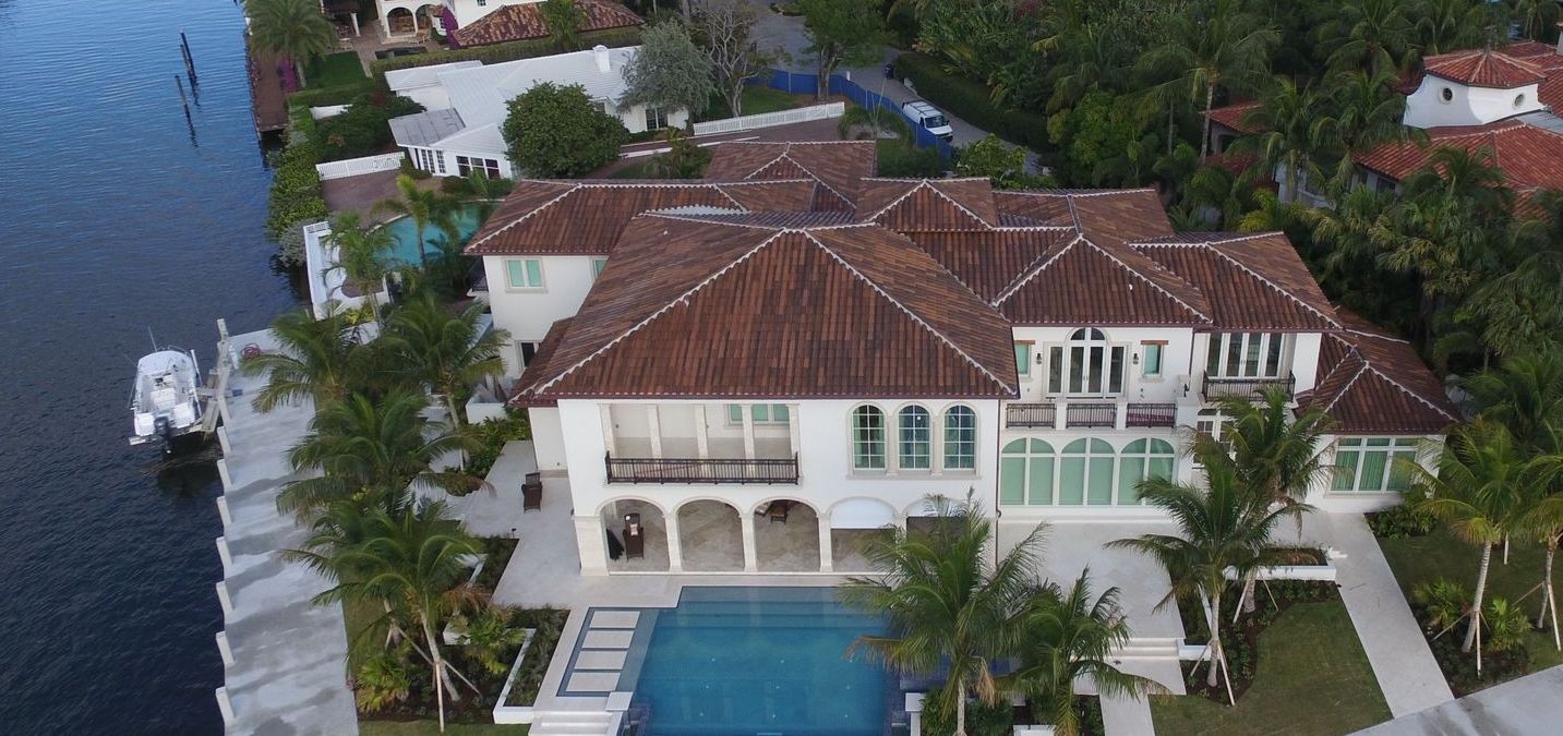 An aerial view of a large house with a swimming pool
