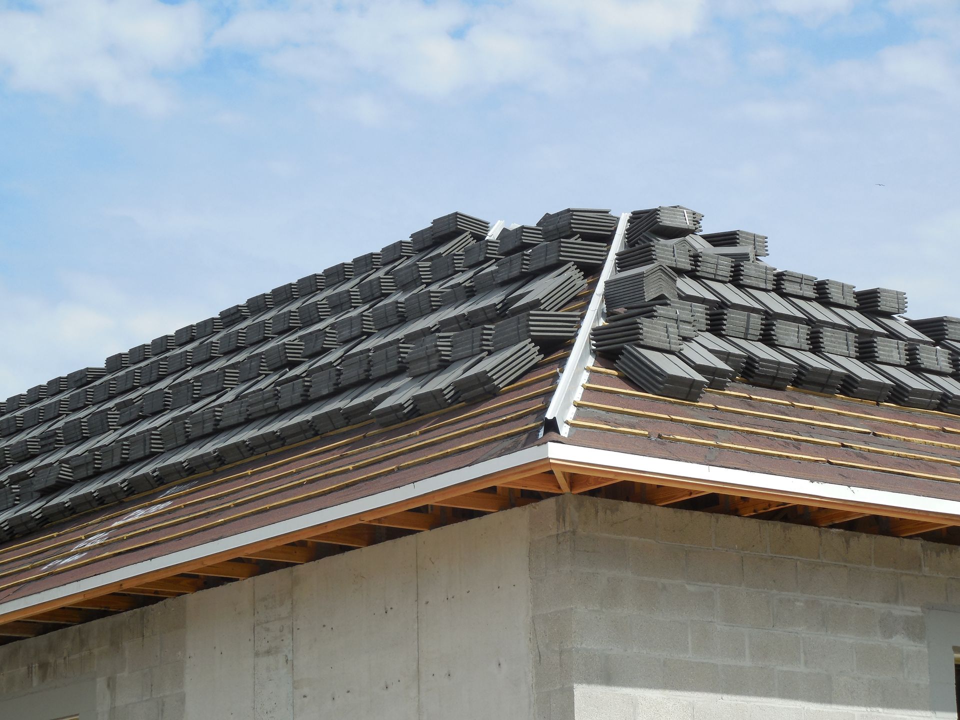 A roof with a lot of tiles on it is being built
