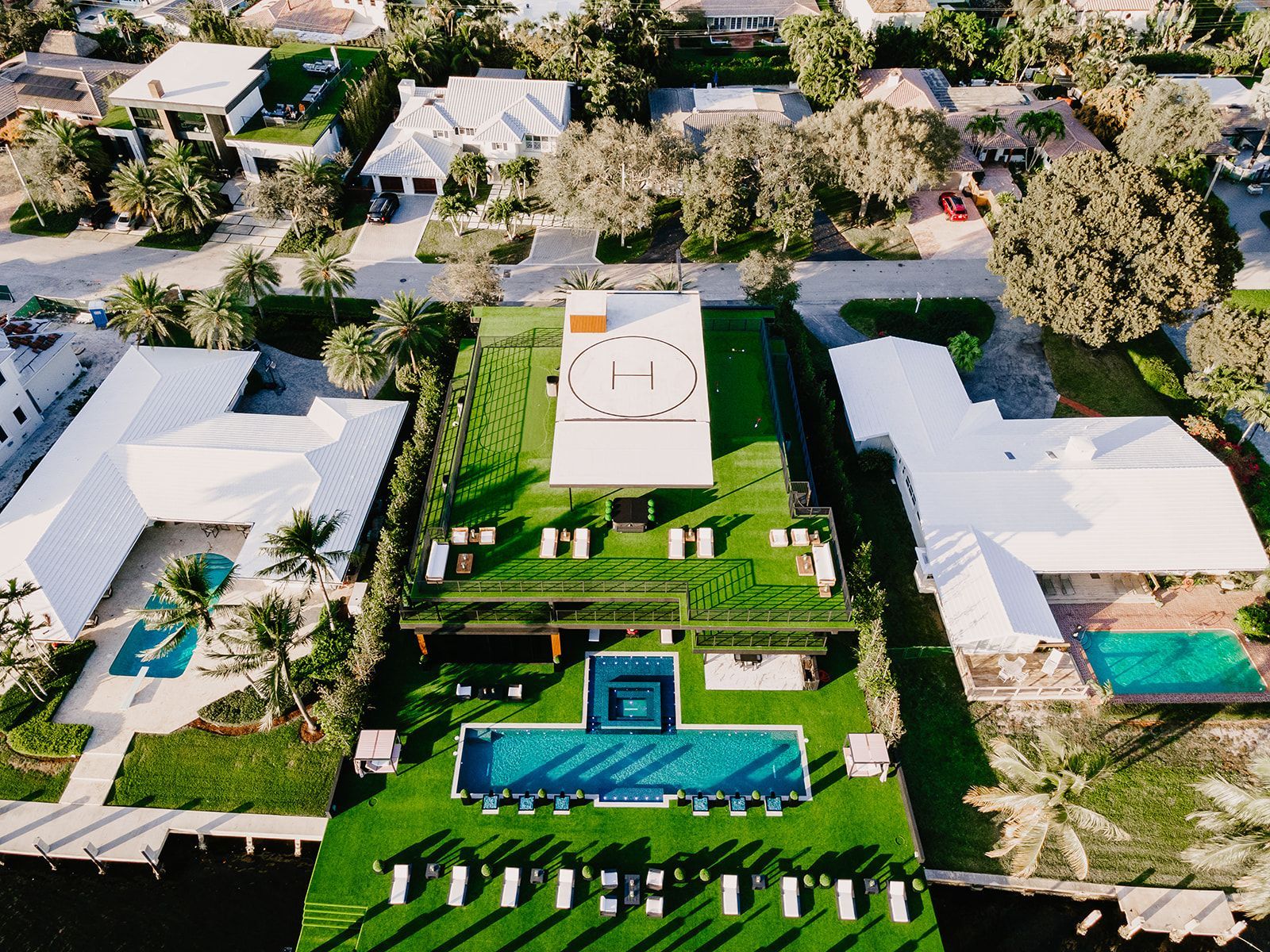 An aerial view of a house with a helicopter on top of it