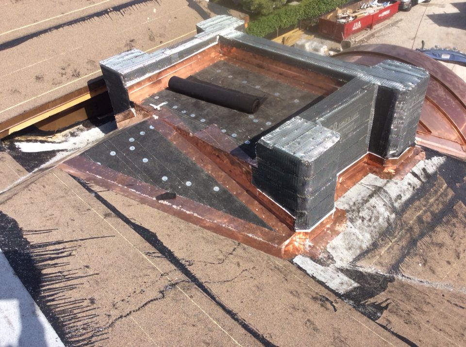 An aerial view of a roof with a copper roof