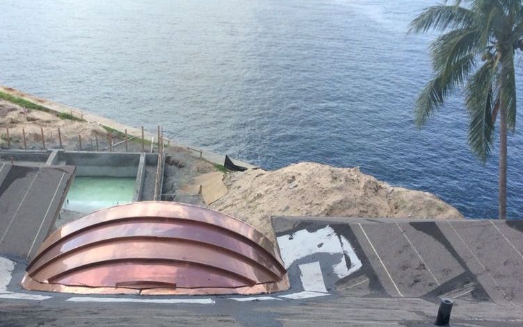 A view of the ocean from the top of a building.