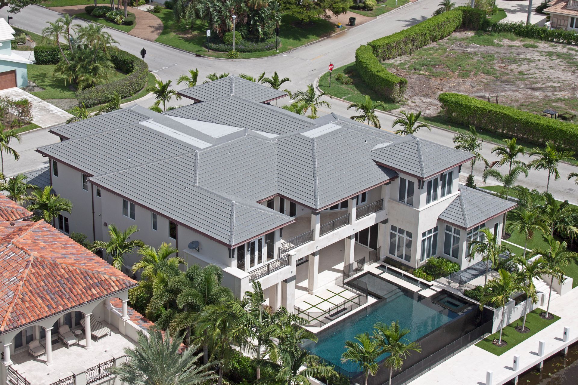 An aerial view of a large house with a swimming pool