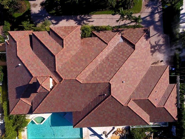 An aerial view of a large house with a pool