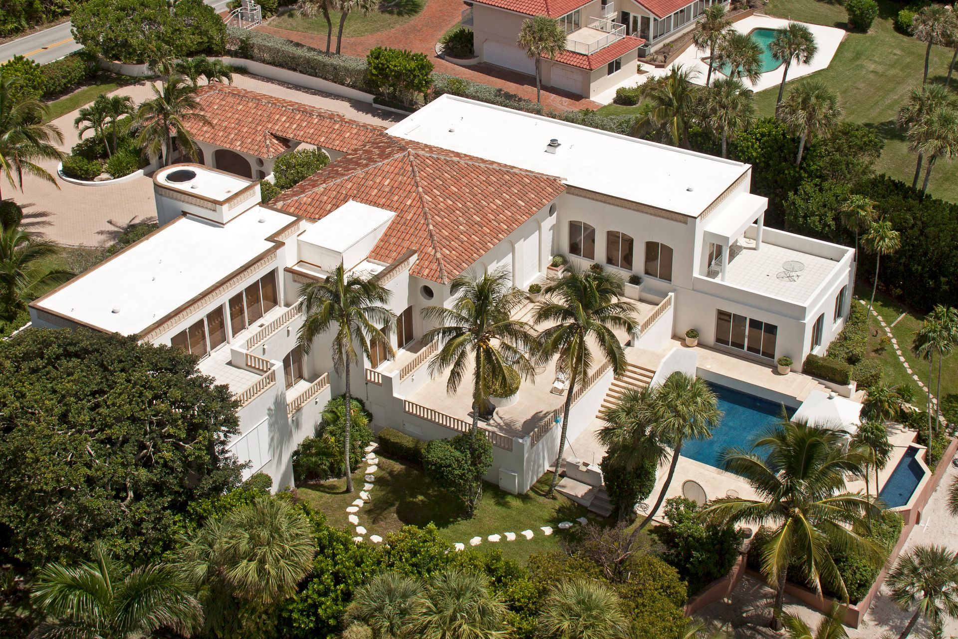 An aerial view of a large house with a pool