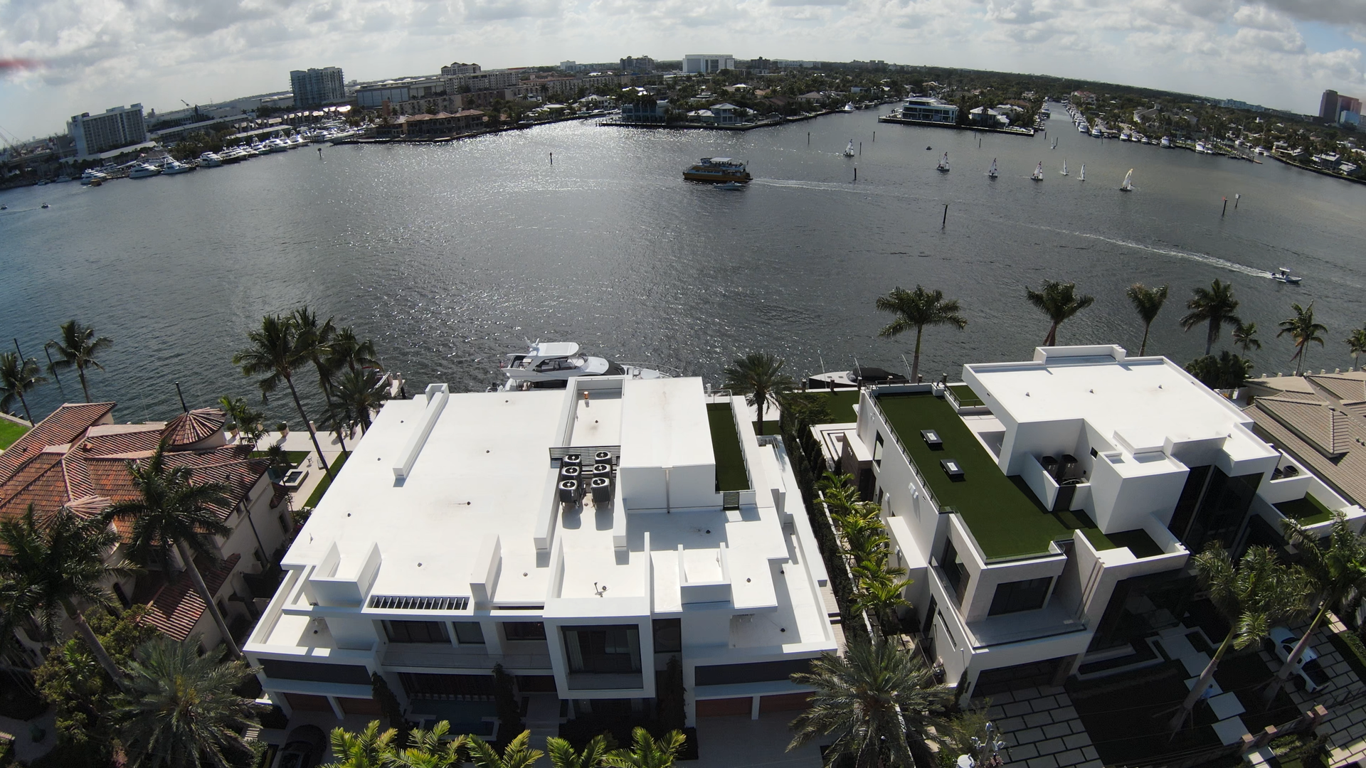 An aerial view of a residential area with a large body of water in the background