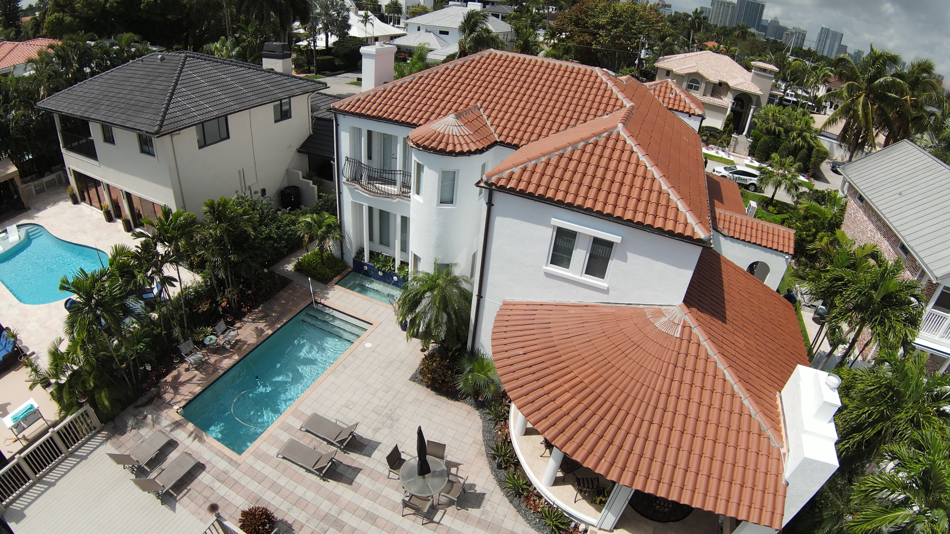 An aerial view of a large house with a pool