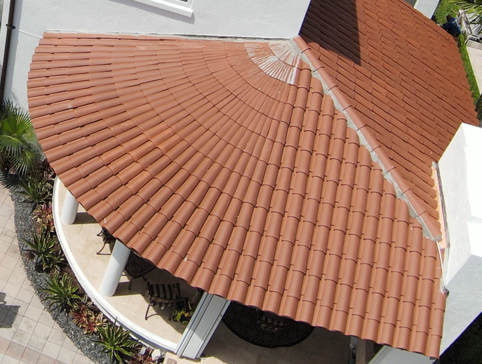 An aerial view of a house with a curved roof
