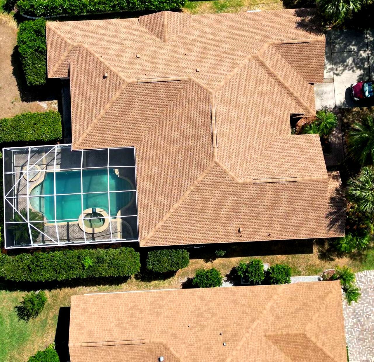An aerial view of a house with a pool