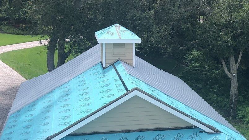 An aerial view of a house with a blue roof.