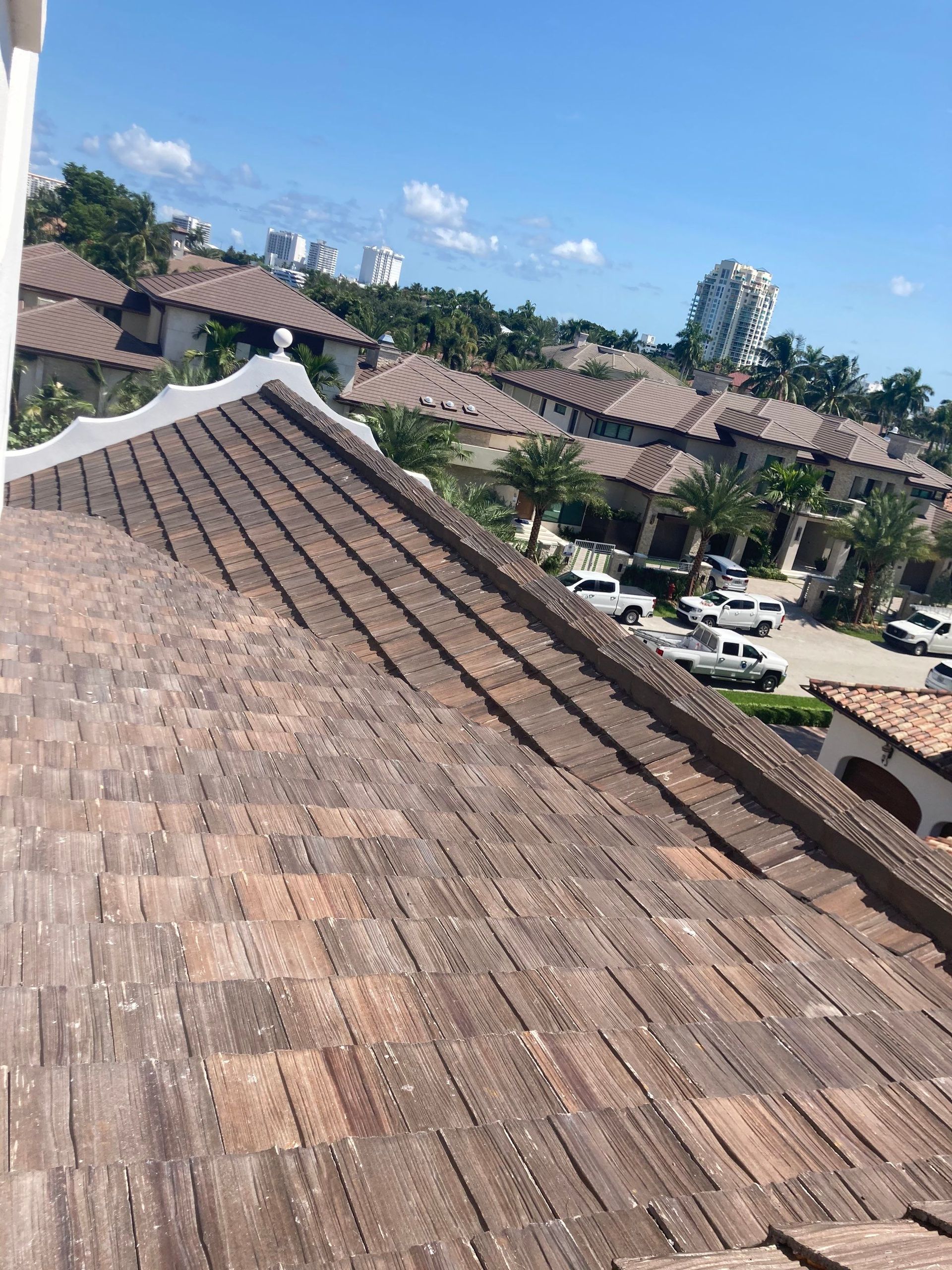 A roof with a lot of tiles on it and a city in the background.