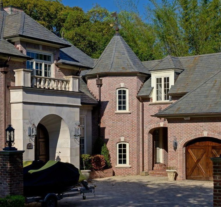 A large brick house with a tower on top of it