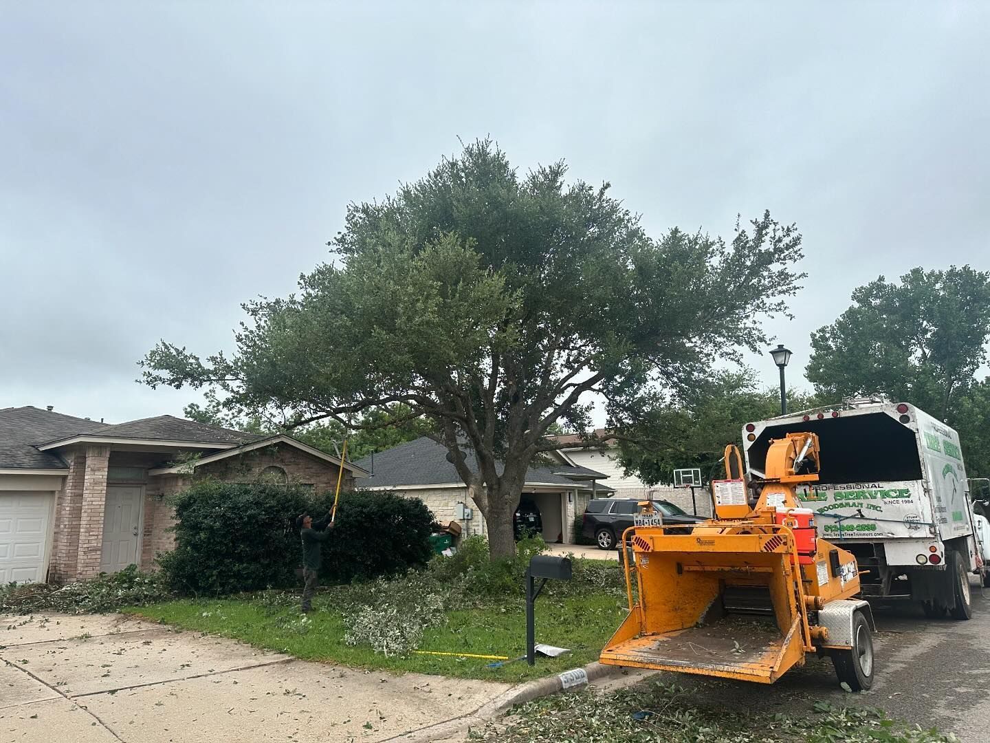 A tree chipper is parked in front of a house.