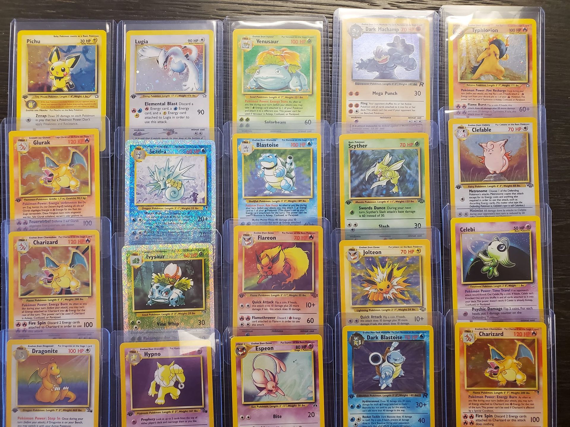 A collection of pokemon cards are lined up on a table