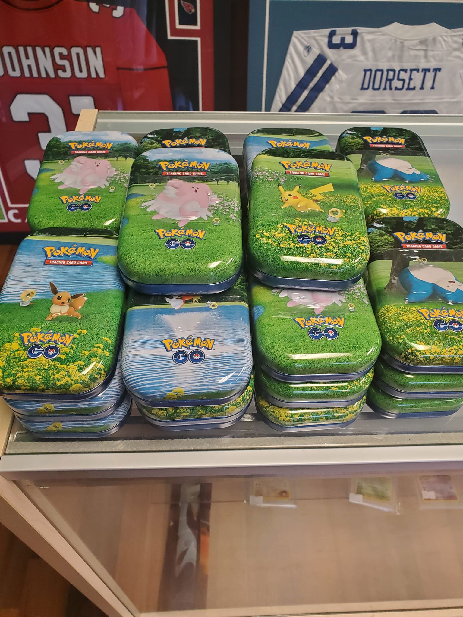 A bunch of pokemon cards are stacked on top of each other on a table.