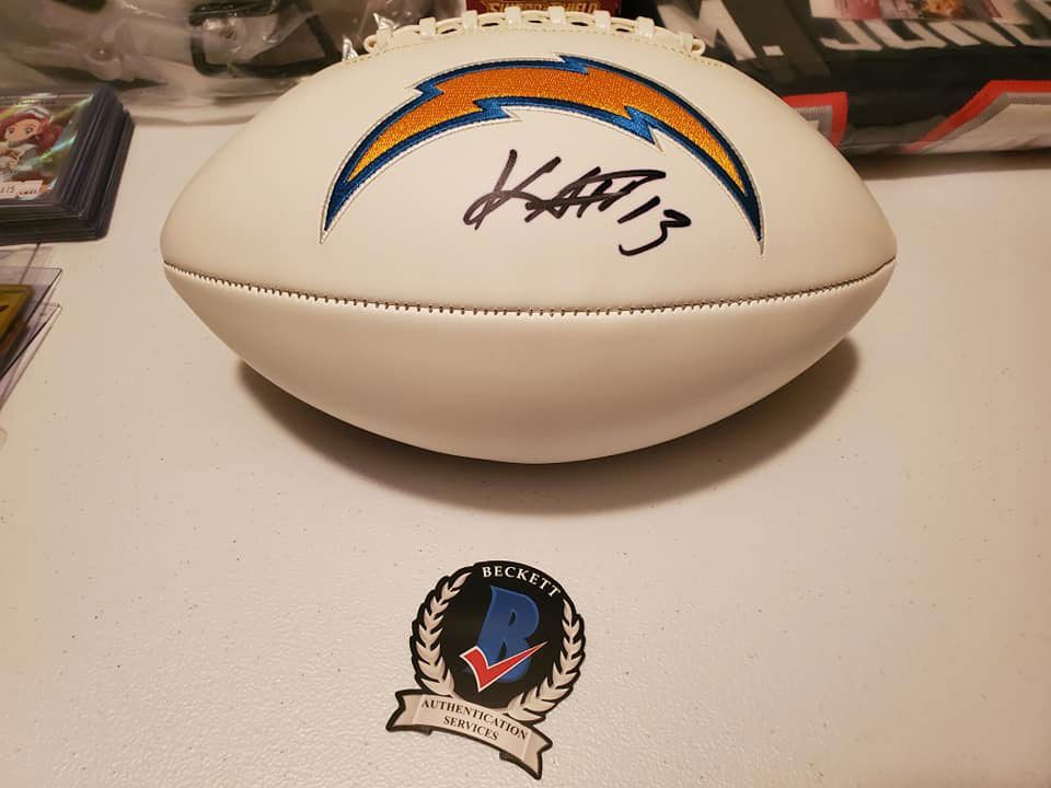 A signed la chargers football sits on a table