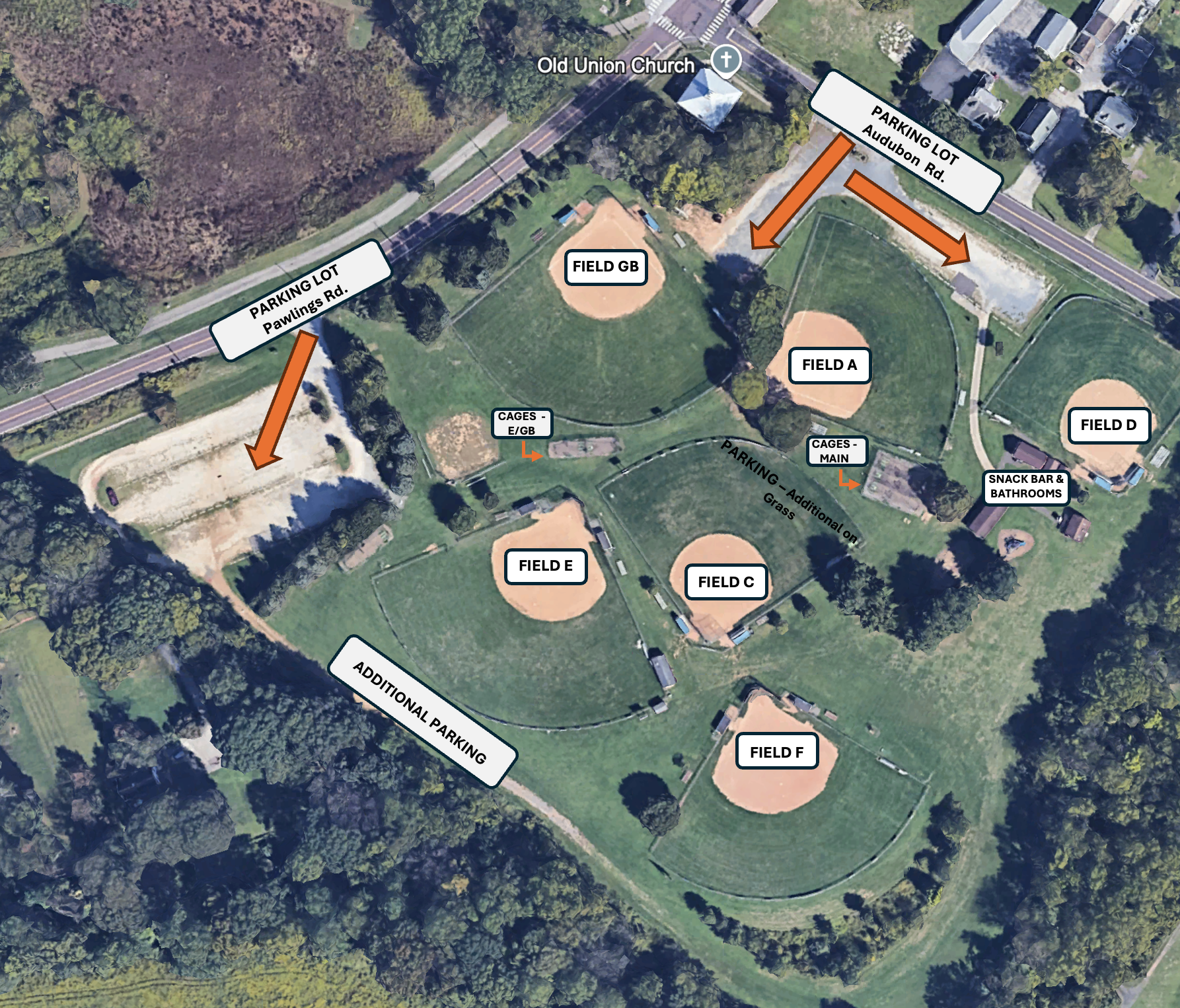 An aerial view of a baseball field with a parking lot