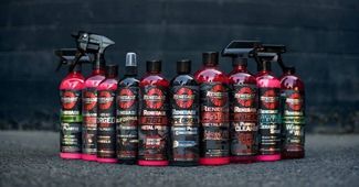 A row of bottles of cleaning products are lined up in a row.