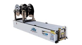 A machine is sitting on top of a table on a white background.