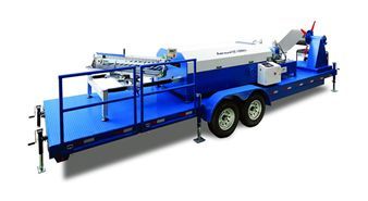 A blue trailer with a machine on it on a white background.