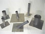 A group of metal pipes sitting on top of metal plates on a table.