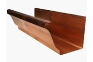 A close up of a copper gutter on a white background.