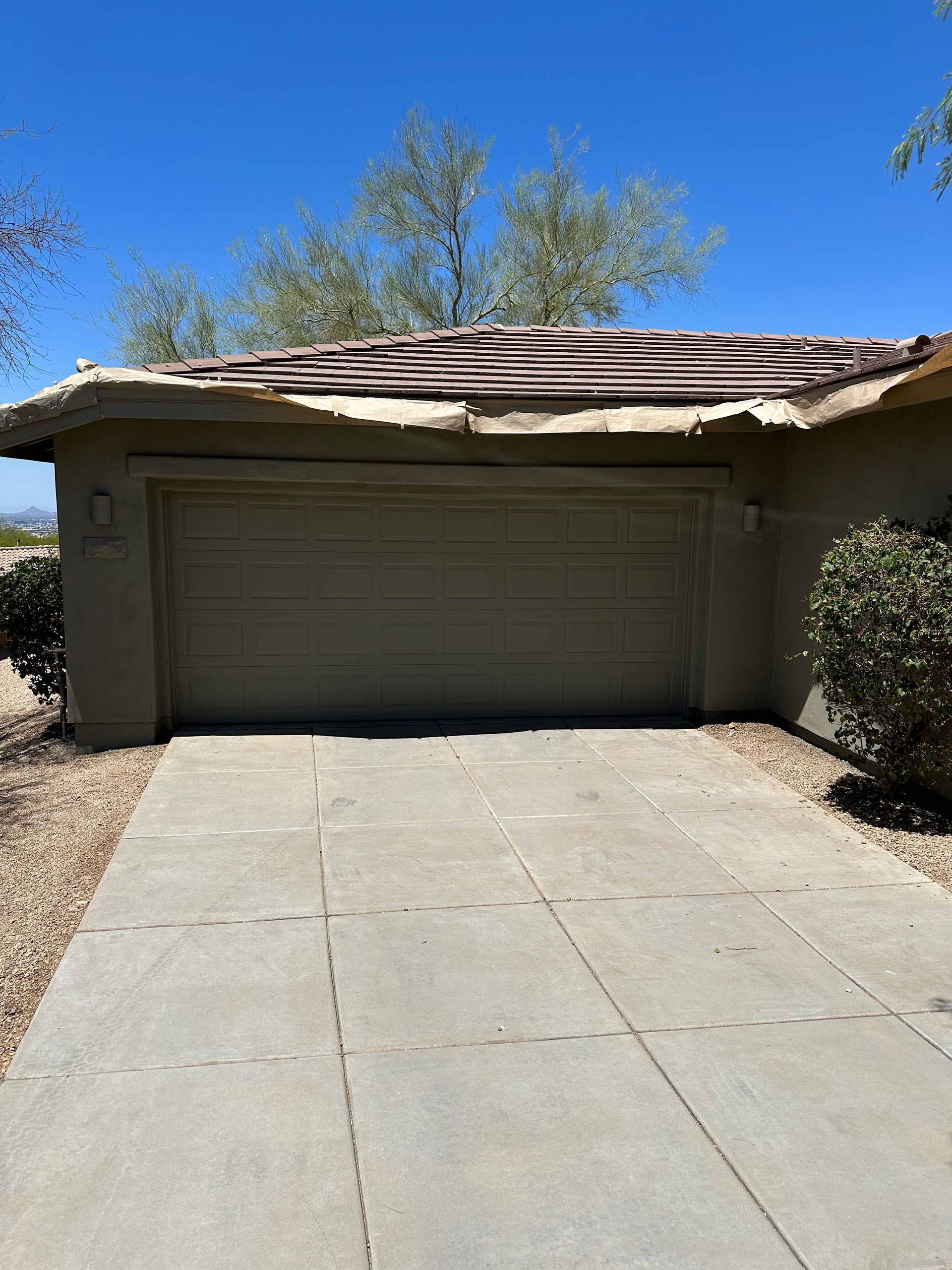 A garage with a roof that has been damaged by a storm.