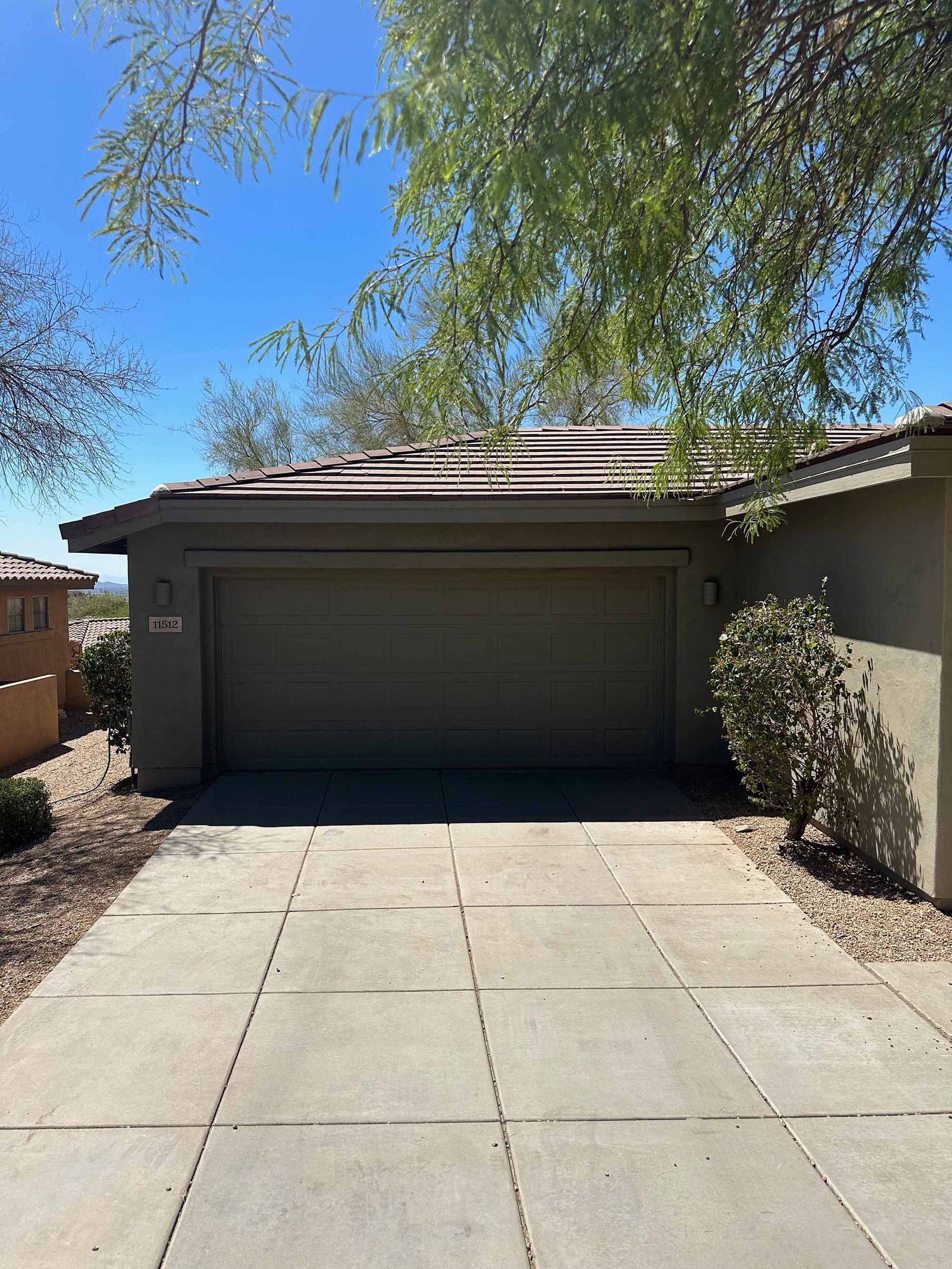 A house with a garage and a driveway leading to it