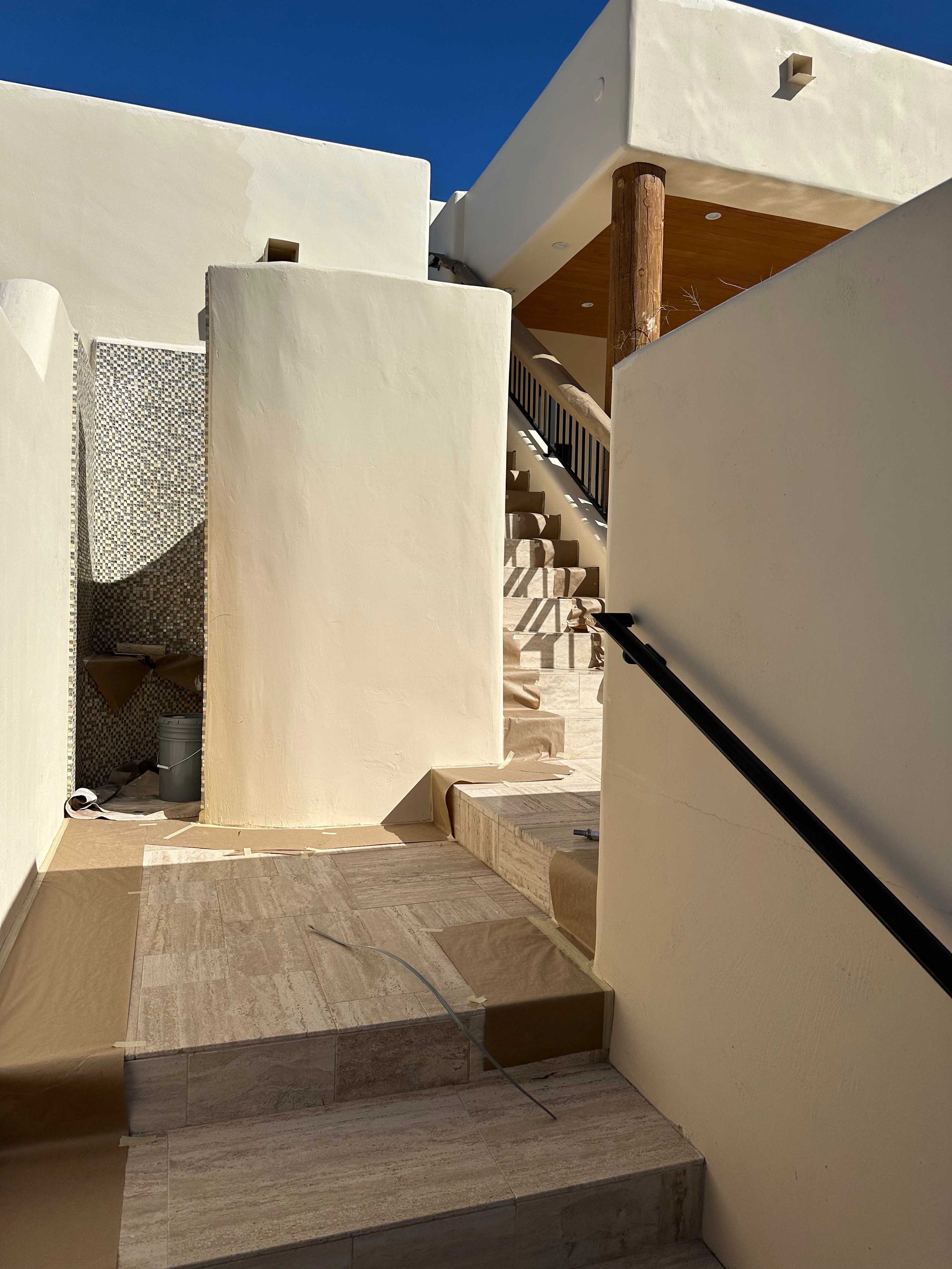 A white building with stairs leading up to it