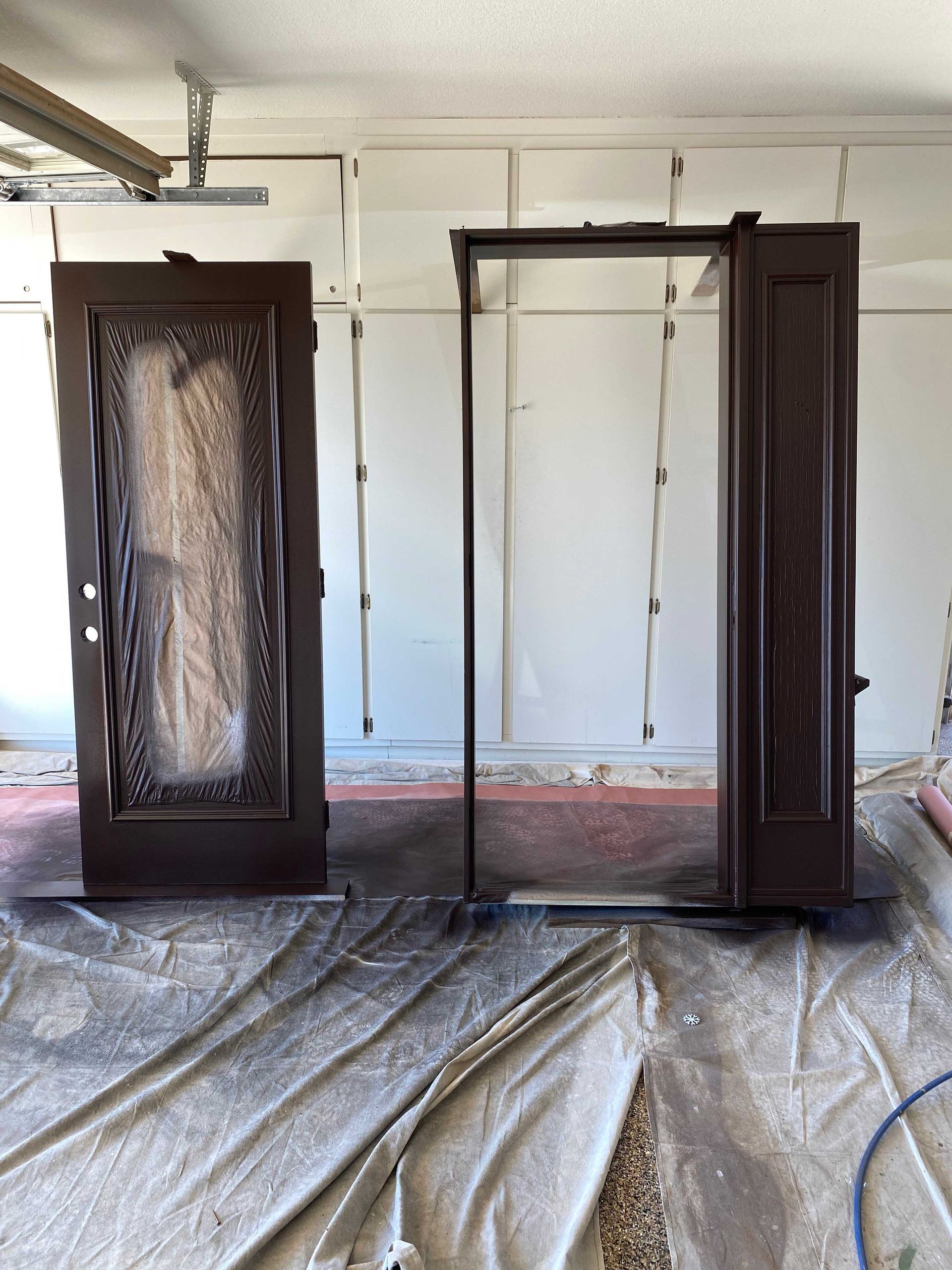 Two brown doors are sitting in a room with a white wall