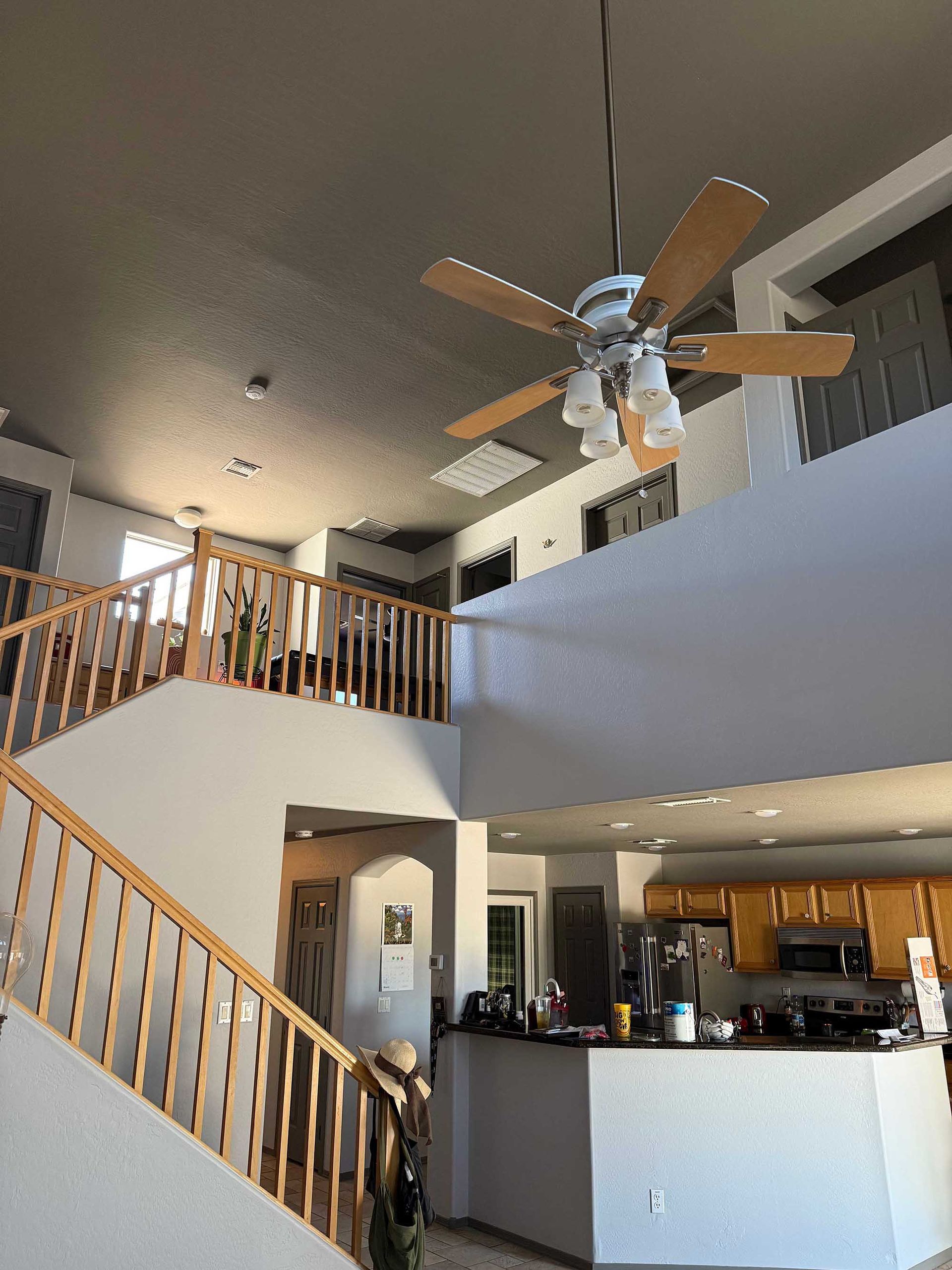 A ceiling fan is hanging from the ceiling of a house.