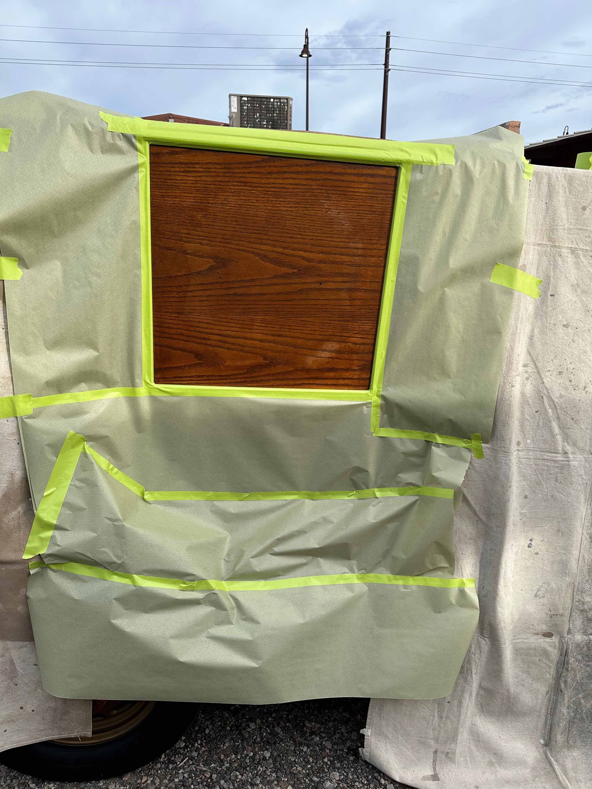 A piece of wood is covered in green tape