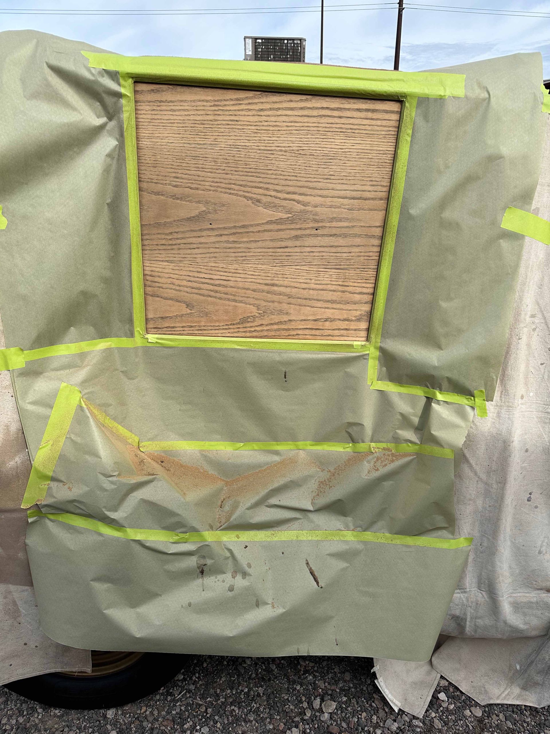 A piece of wood is taped to a piece of paper