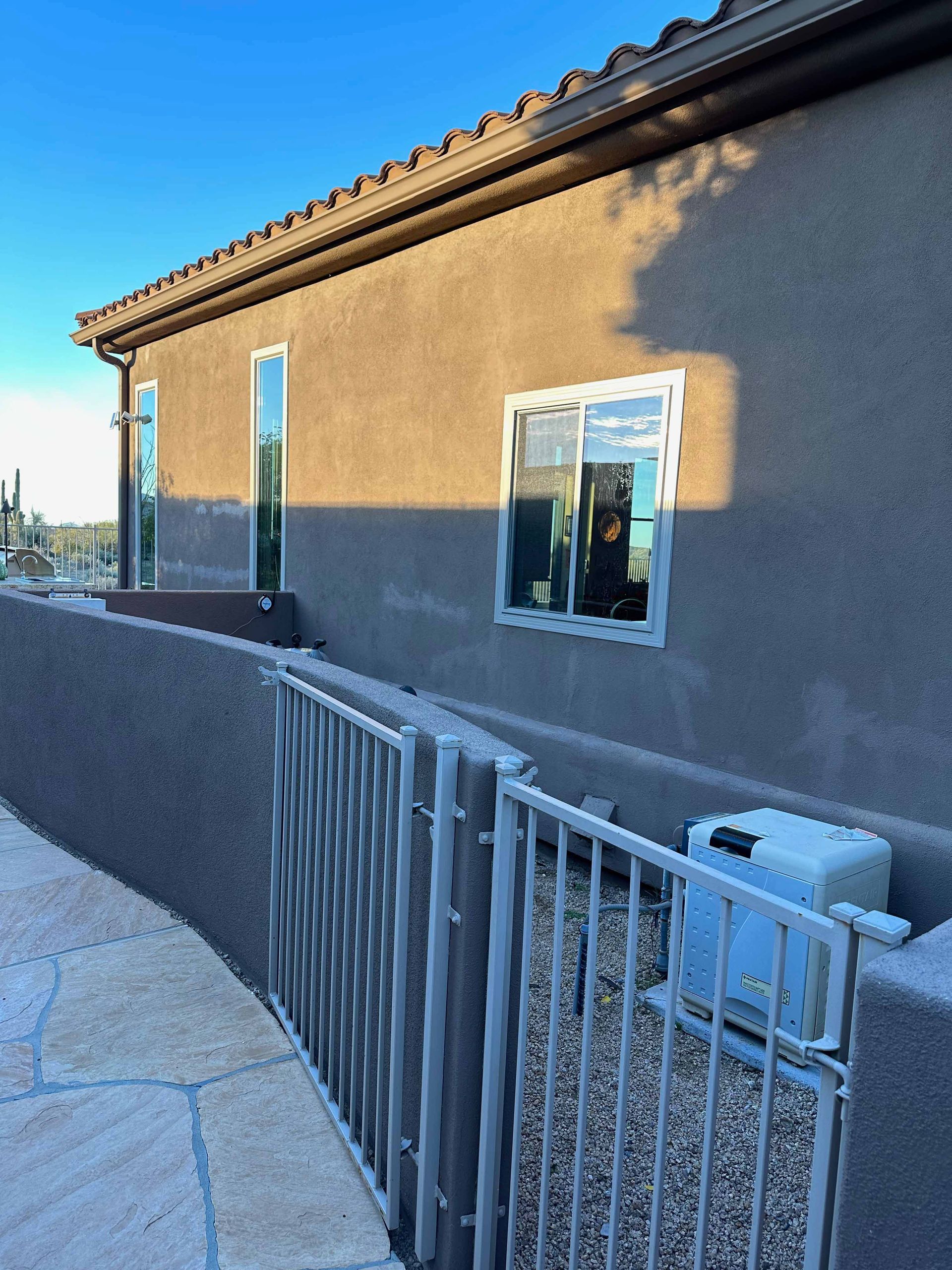 A house with a fence and a few windows
