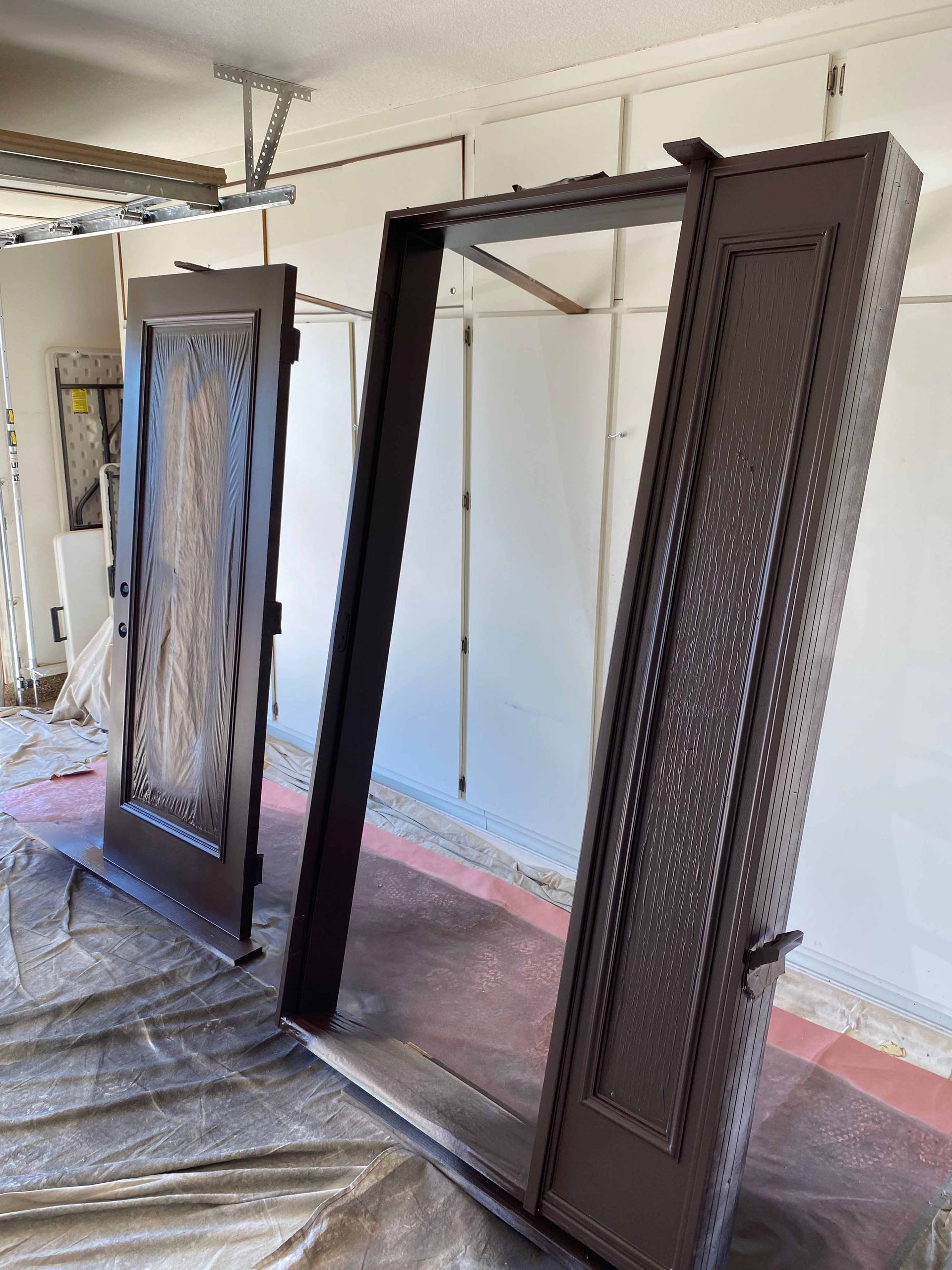 Two doors are sitting on a table in a garage.