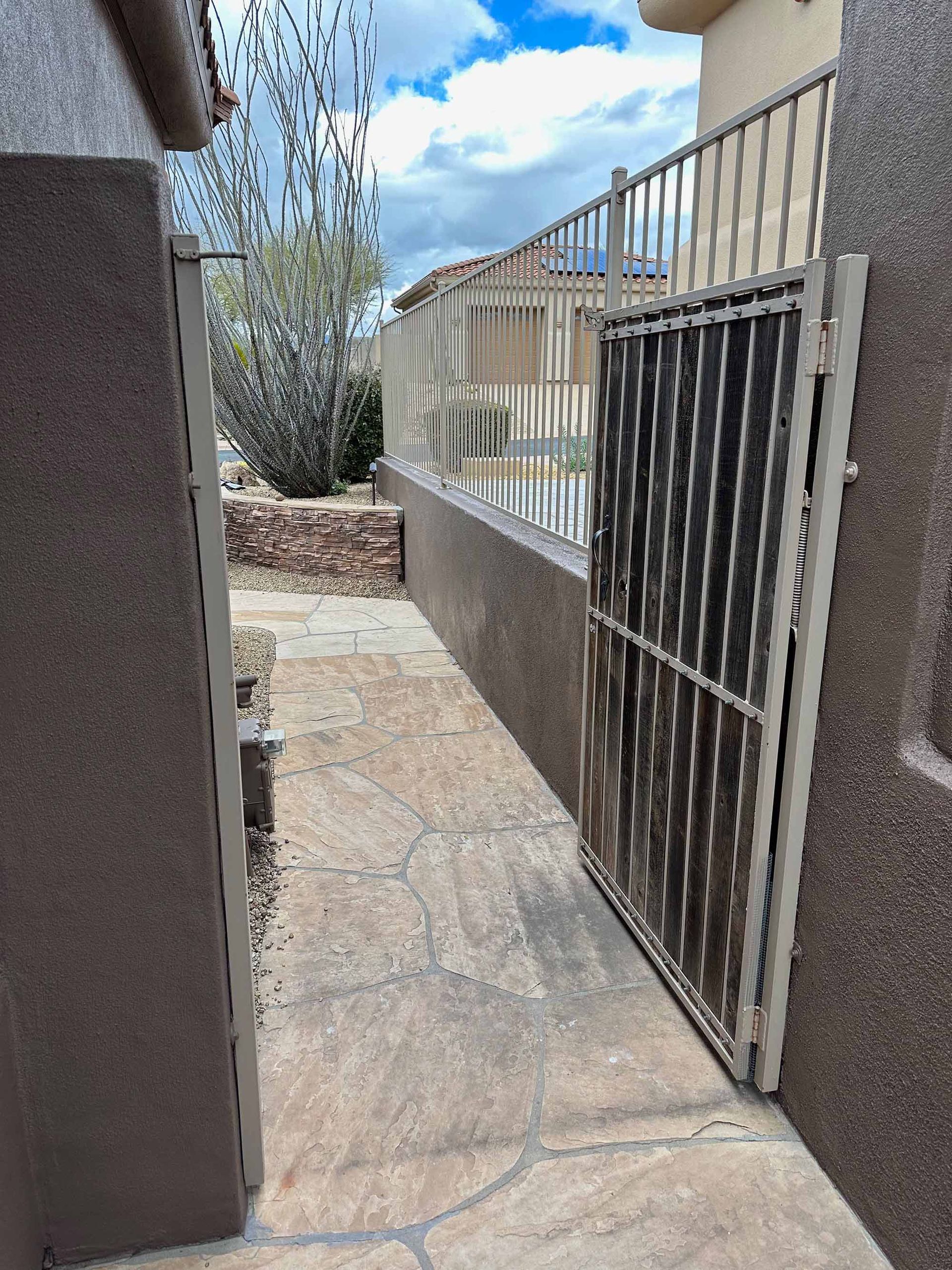 A walkway with a gate between two buildings
