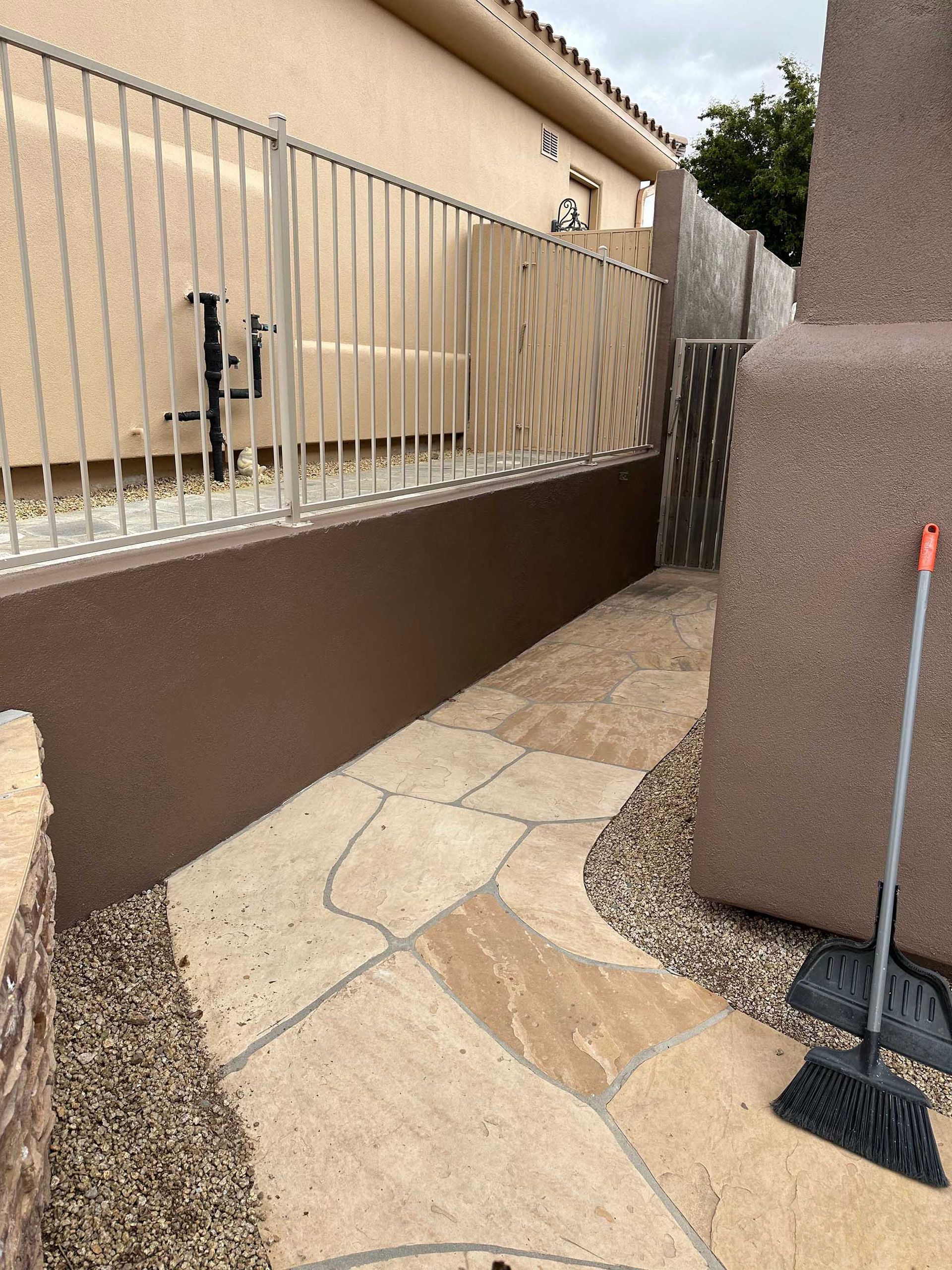 A broom is sitting on the sidewalk in front of a building