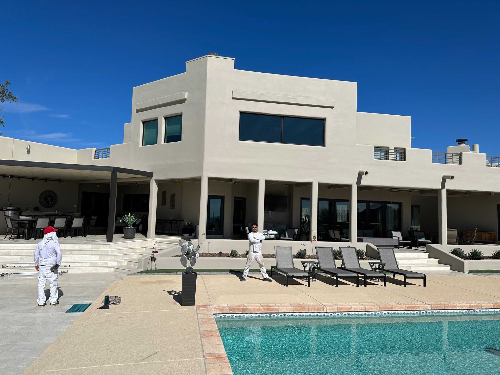 A large white house with a swimming pool in front of it