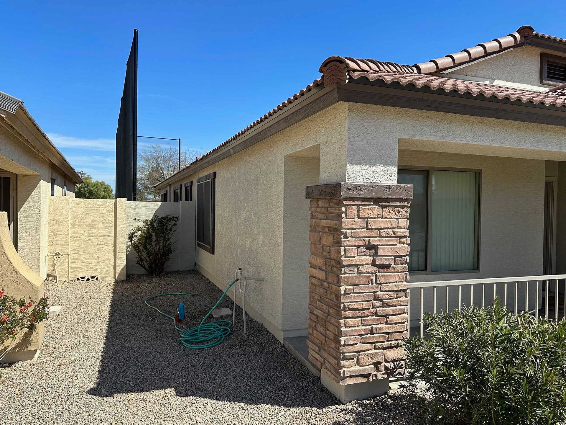 A house with a green hose in front of it