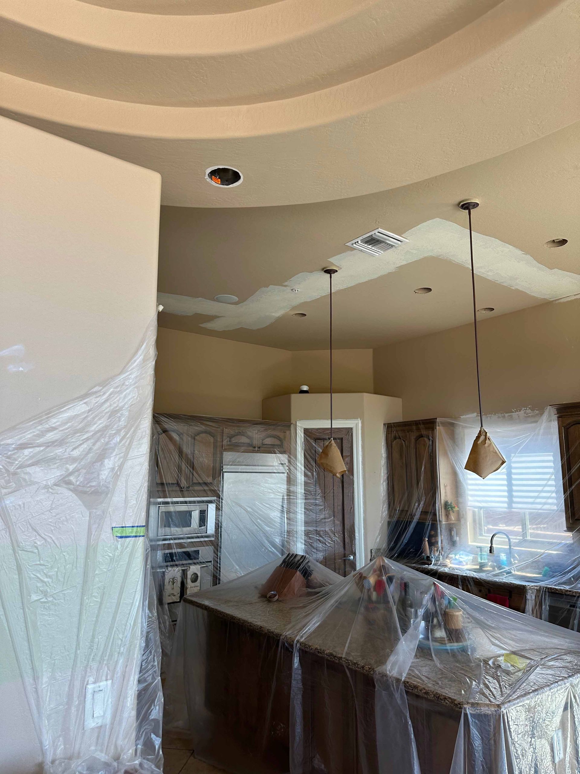 A kitchen with a ceiling that is covered in plastic.