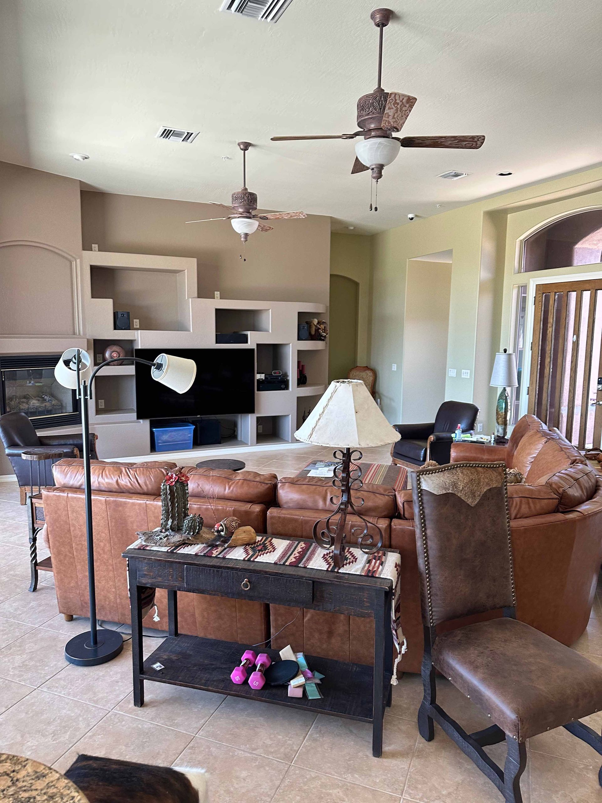 A living room filled with furniture and a ceiling fan